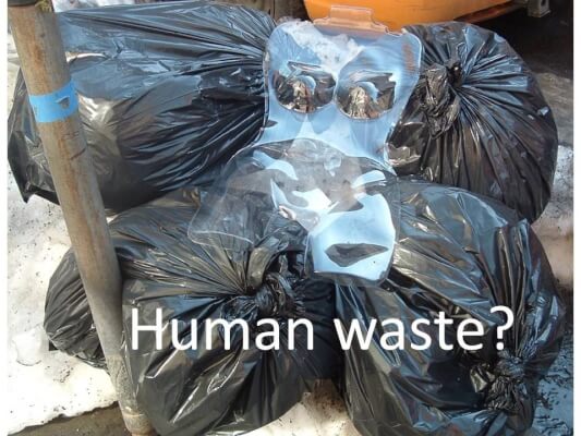 Human waste in garbage bags