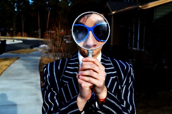 Privacy - Image of person being examined by magnifying glass