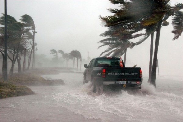 truck driving through waves and wind from hurricane