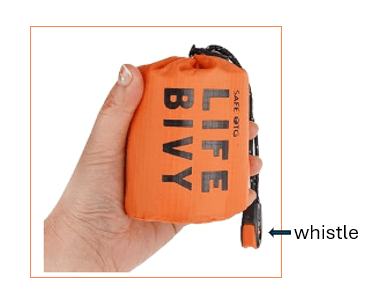 Image of hand holding orange Bivy Bag with attached emergency whistle